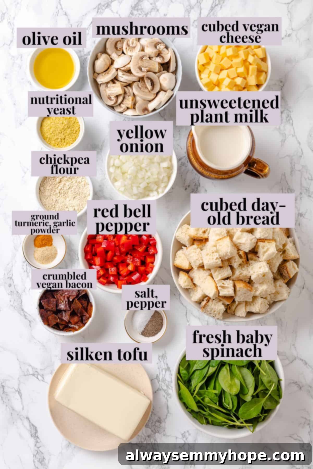 An overhead view of an assortment of fresh ingredients, including bread, bell peppers, mushrooms, and spinach, arranged on a counter, ready for preparing the breakfast strata recipe.