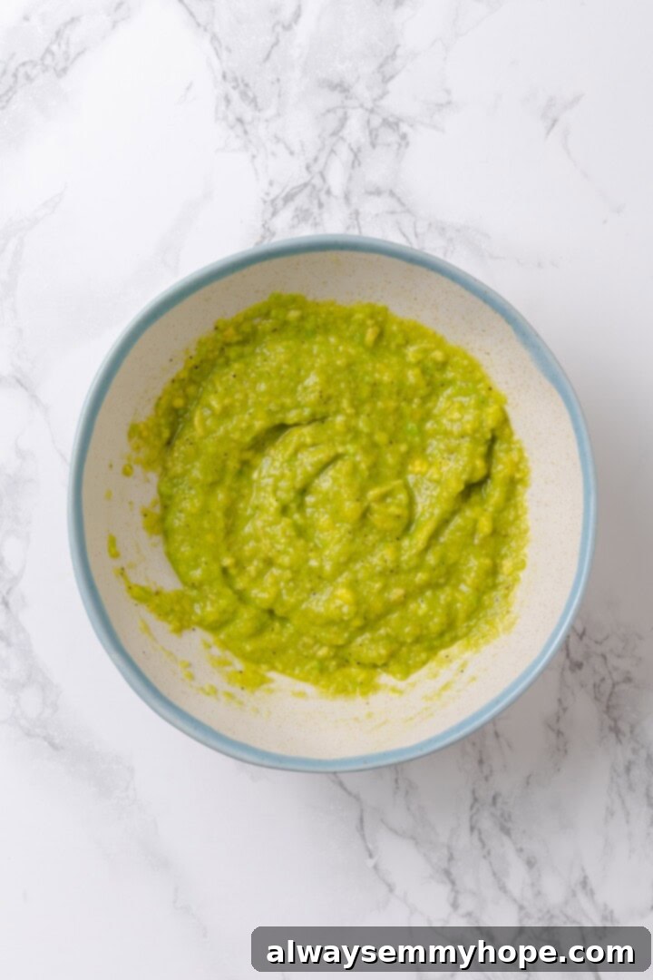 Overhead view of vibrant green avocado slime in a white bowl