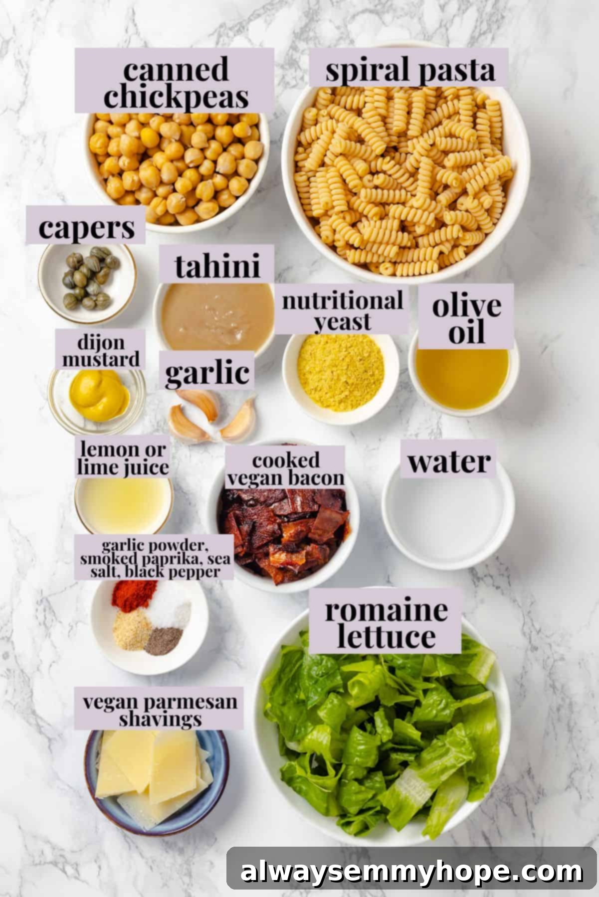This vegan Caesar Pasta Salad is savoury, tangy and garlicky, with crunchy baked chickpeas, crisp romaine and tender pasta. Delicious! Overhead view of ingredients for caesar pasta salad.