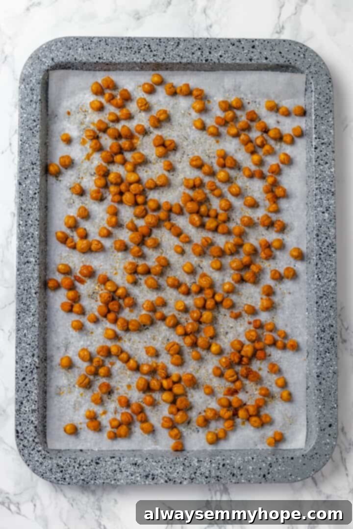 This vegan Caesar Pasta Salad is savoury, tangy and garlicky, with crunchy baked chickpeas, crisp romaine and tender pasta. Delicious! Crispy roasted chickpeas on sheet pan.