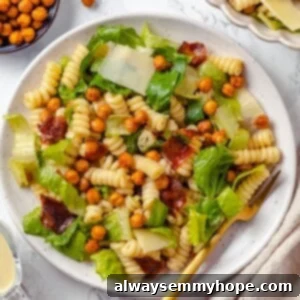 Zesty Caesar Pasta Salad with Crunchy Chickpeas 2 Caesar pasta salad on plate with fork.
