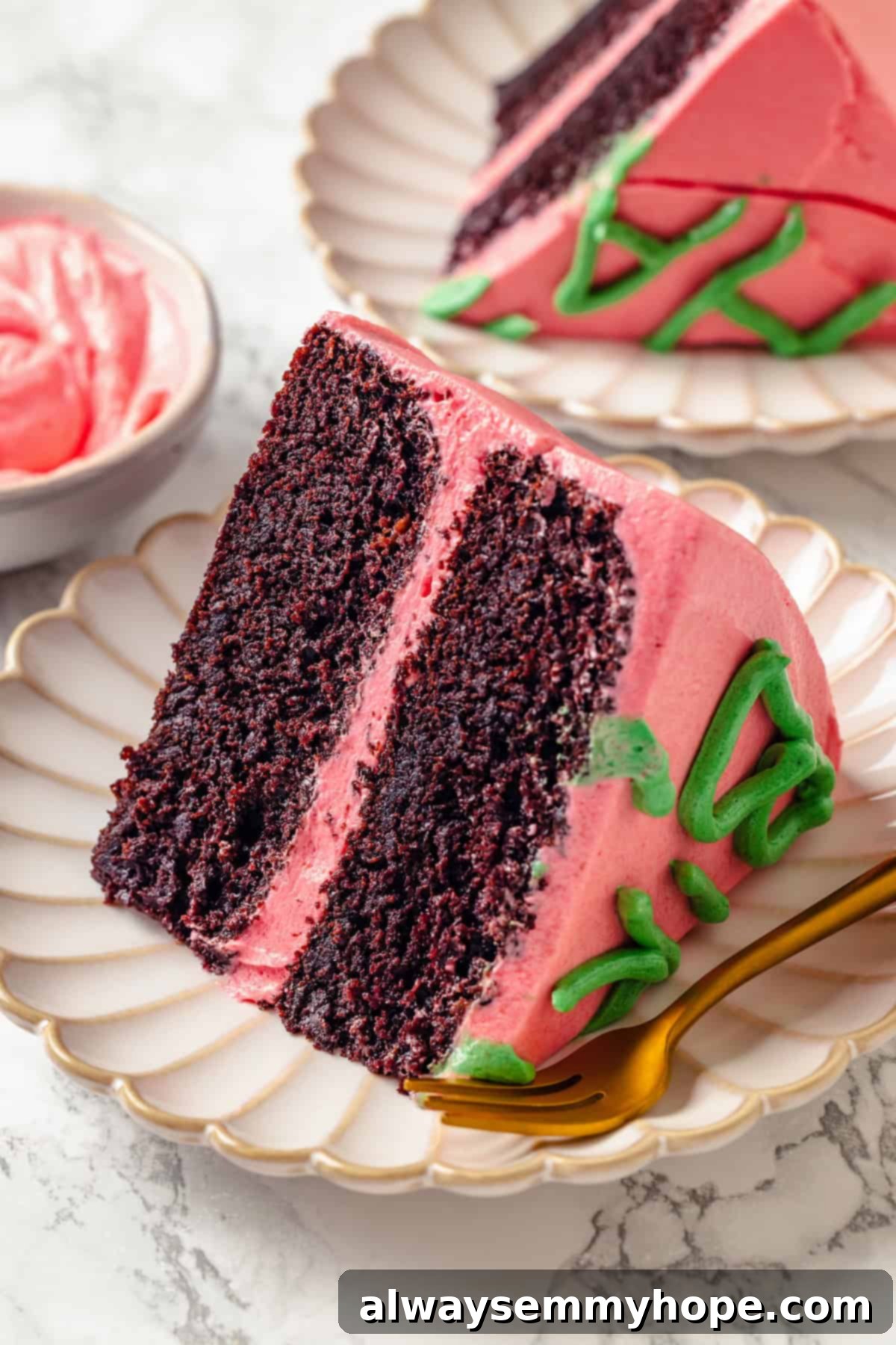 A perfectly cut slice of Harry Potter cake on a plate with a fork, showing the moist chocolate layers and pink frosting.