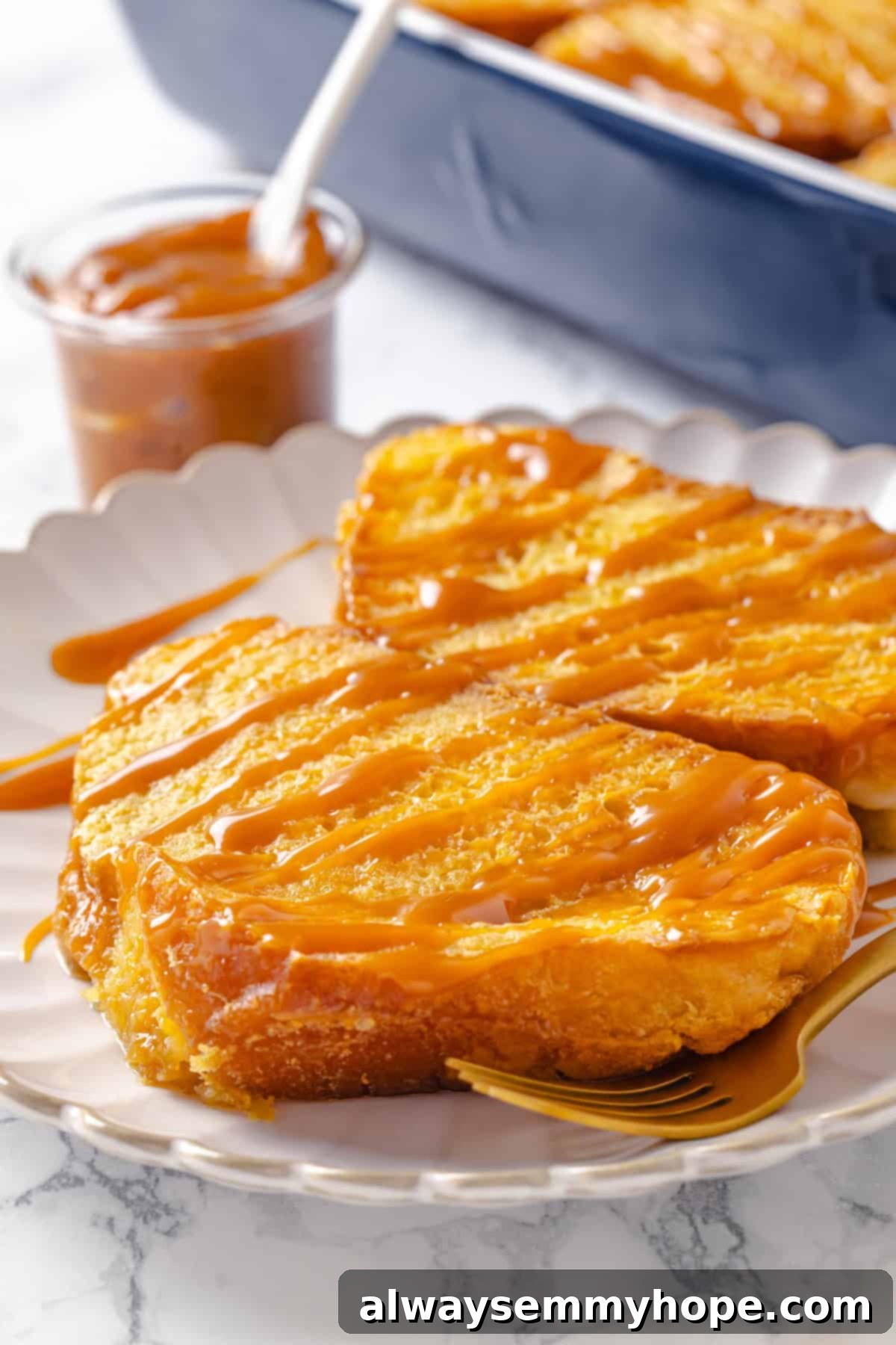 With a rich vegan custard and caramel, this Creme Brûlée French Toast has the flavour of the classic dessert in crowd-pleasing breakfast form! Two slices of creme brulee French toast on plate with caramel drizzle.