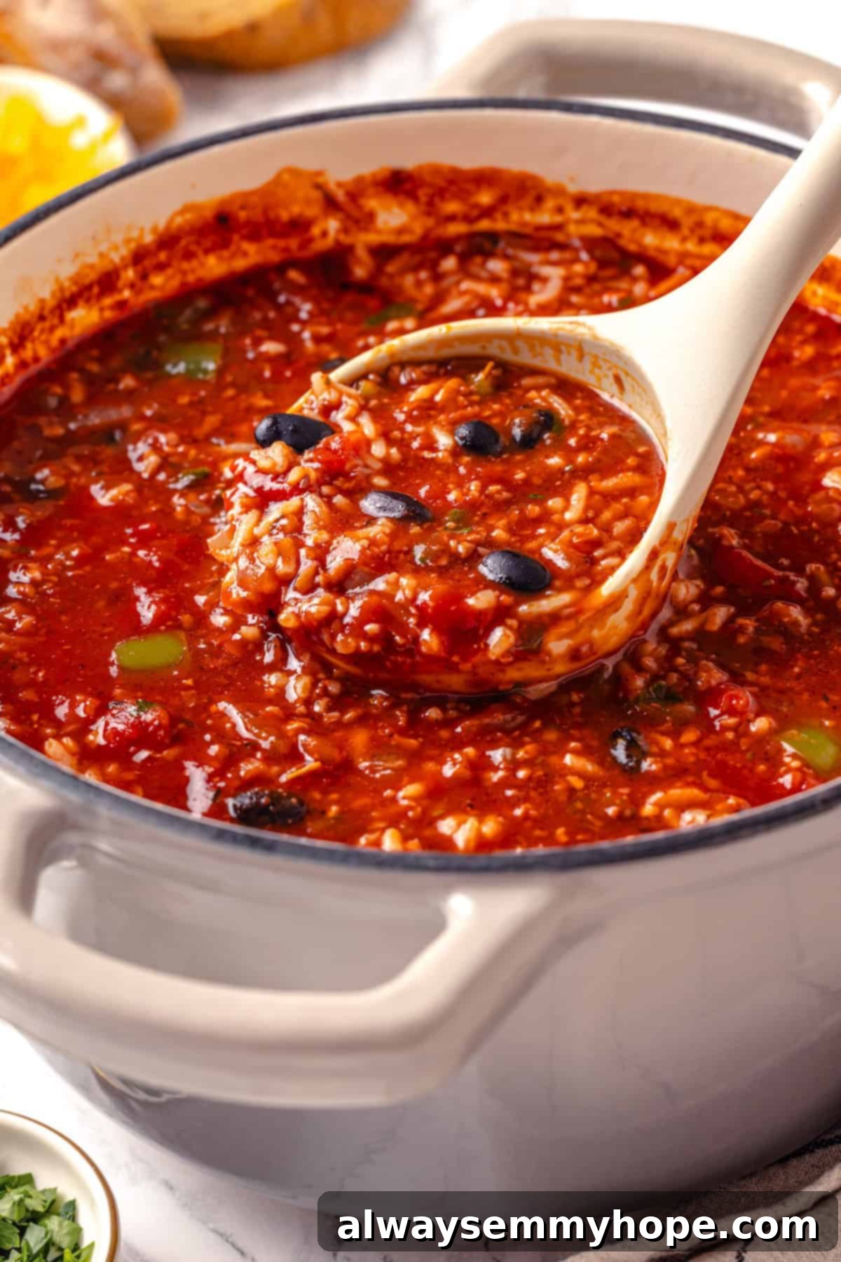 Ladle of vegan stuffed pepper soup.