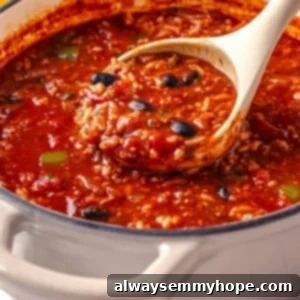 Ladle of vegan stuffed pepper soup.
