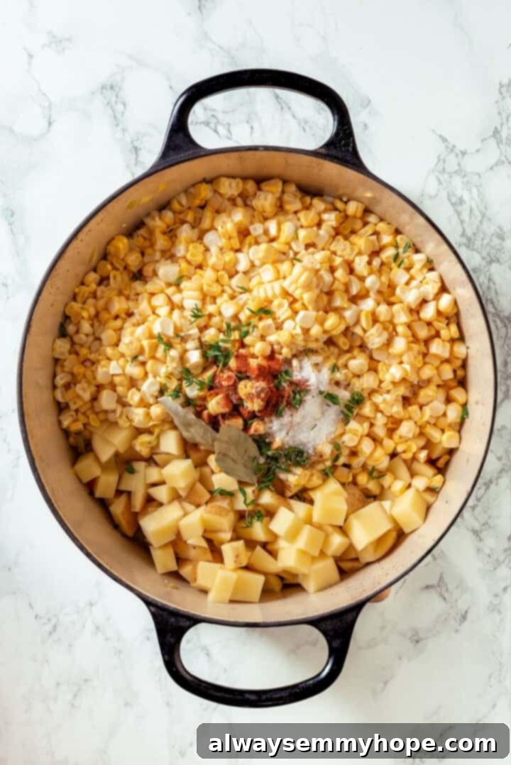 Corn, seasonings, and potatoes added to the Dutch oven.