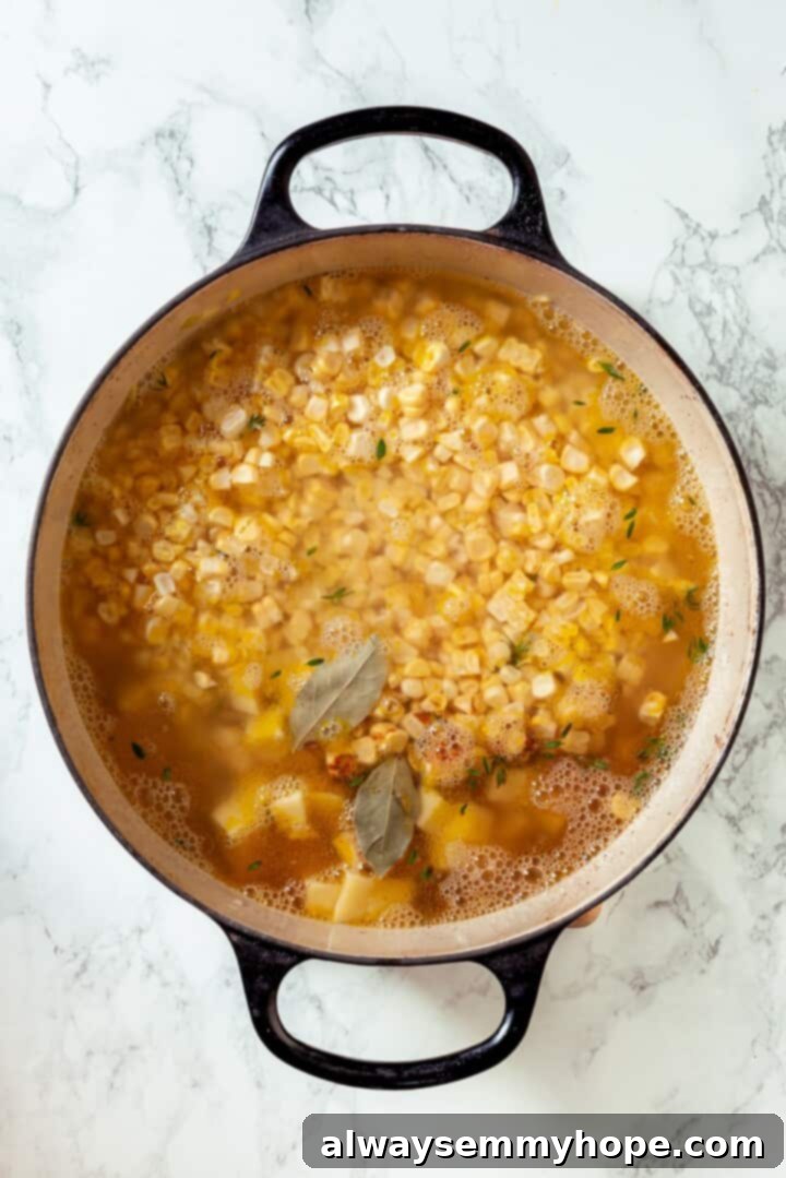 Corn chowder simmering in a Dutch oven.