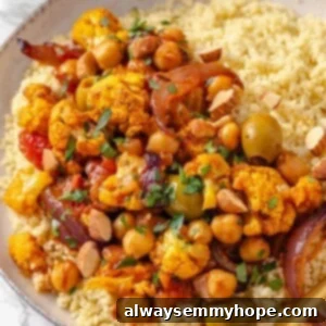 Fragrant Moroccan Cauliflower Chickpea Tagine 2 Bowl of couscous topped with Moroccan cauliflower tagine.