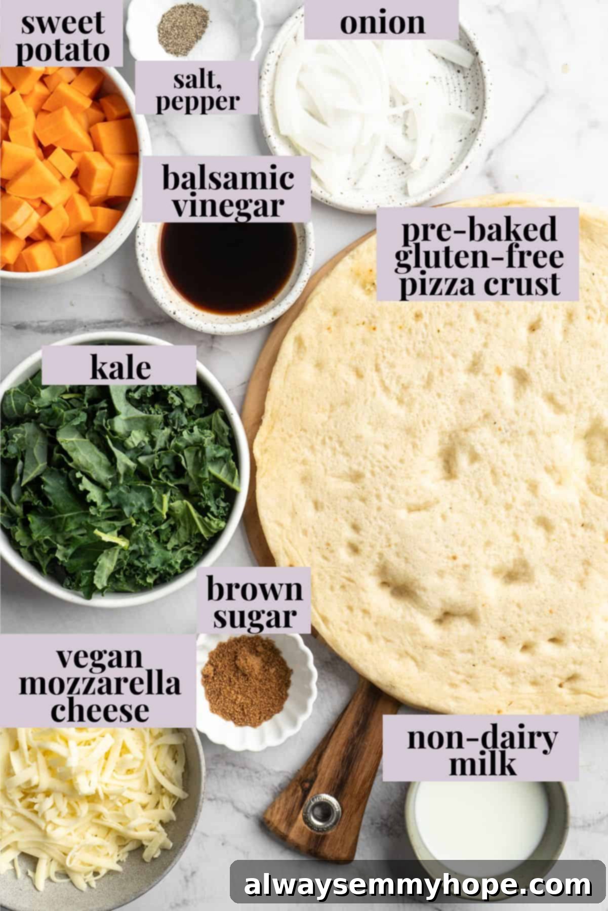 Fresh Ingredients for your Sweet Potato and Kale Pizza: the start of a delicious vegan meal! Overhead view of fresh ingredients for sweet potato and kale pizza, including whole sweet potatoes, vibrant kale leaves, thinly sliced onion, and shredded vegan mozzarella.
