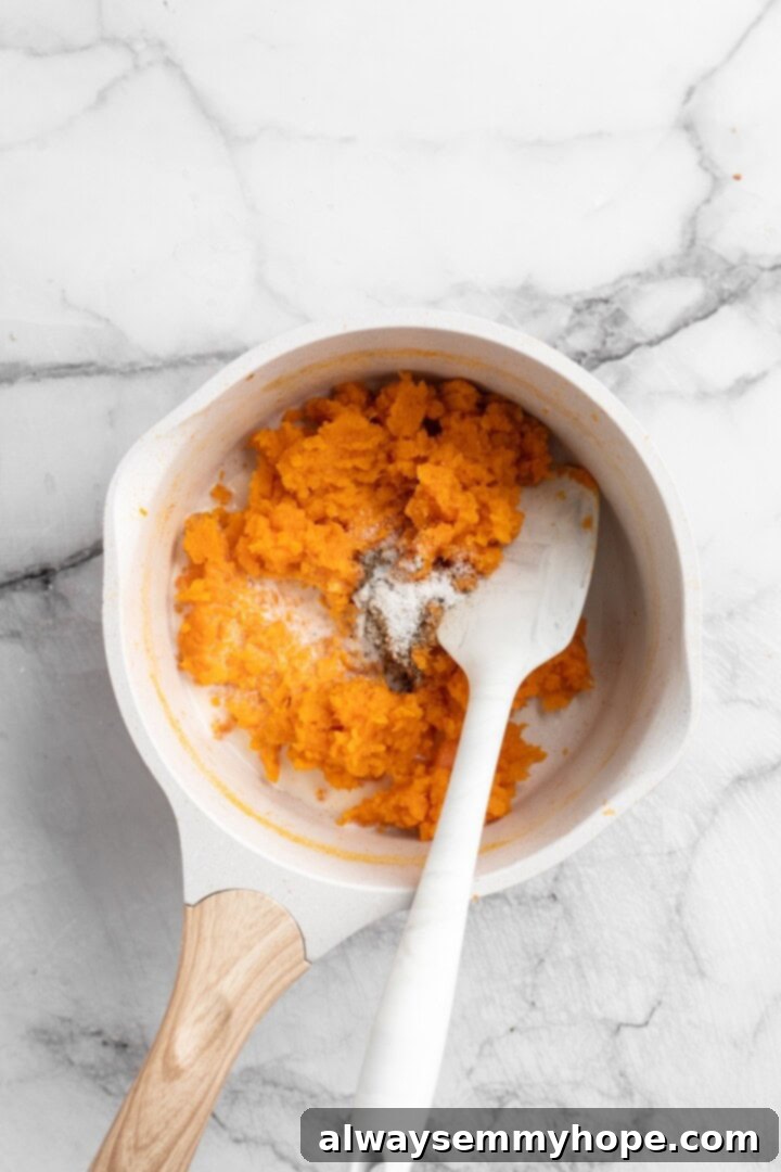 Mash Sweet Potatoes for the Creamy Vegan Pizza Sauce Stirring salt, pepper, non-dairy milk, and mashed sweet potatoes in a pan to create the creamy, smooth sweet potato pizza sauce.