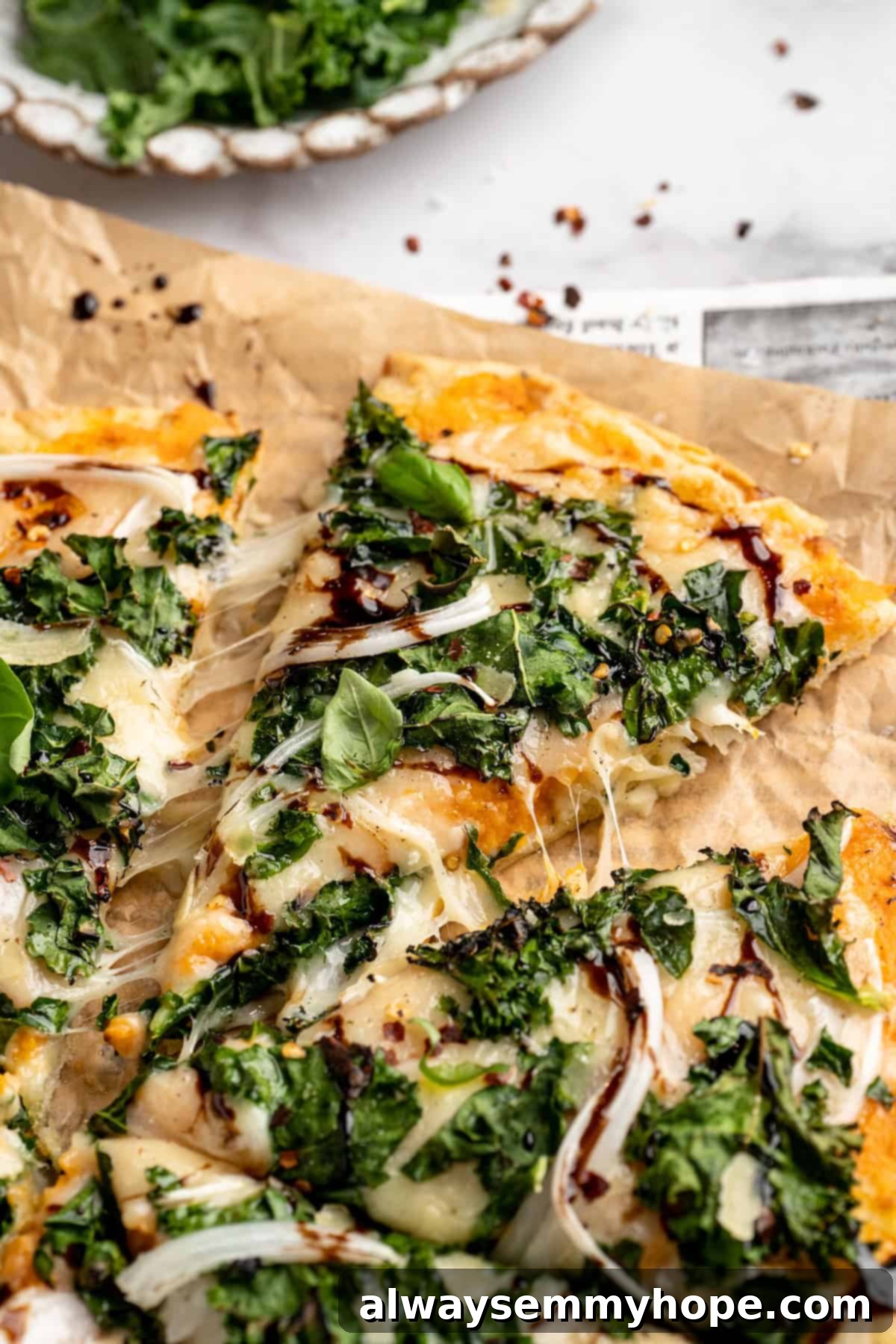 A Delicious Vegan Sweet Potato and Kale Pizza, Ready to Eat A delicious vegan sweet potato and kale pizza with one slice pulled away, showcasing the perfect golden crust and vibrant toppings.