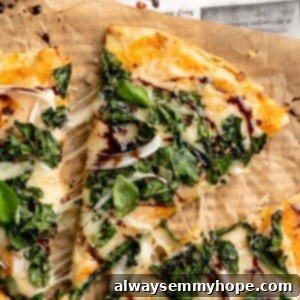 Balsamic Glazed Sweet Potato Kale Pizza 2 Overhead view of sweet potato and kale pizza with one slice pulled away slightly