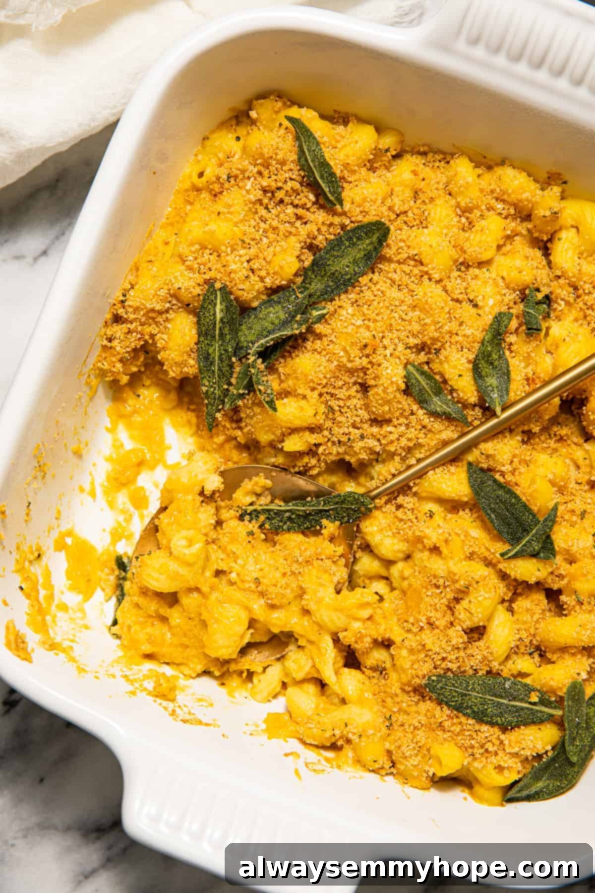 Vegan Butternut Squash Mac and Cheese 4 A bowl of creamy butternut squash mac and cheese garnished with fresh sage leaves.