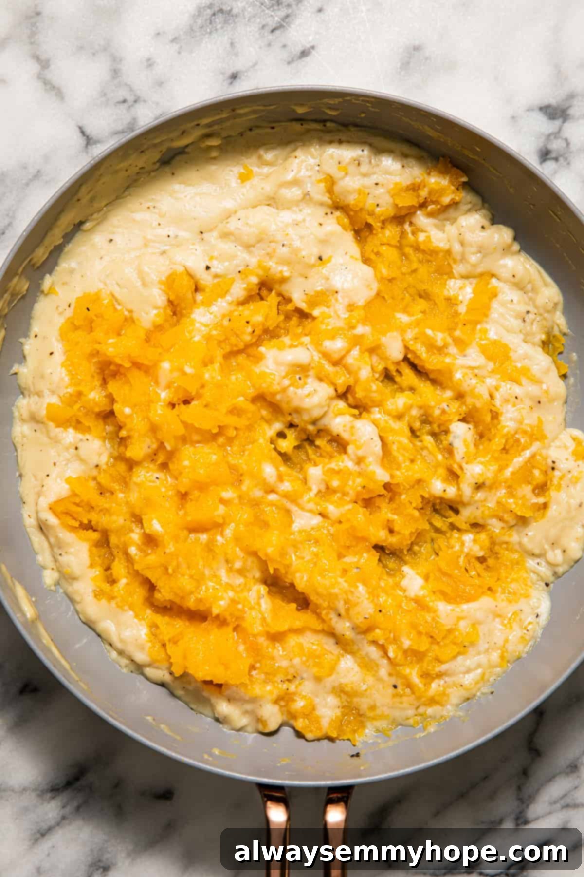 Mashed butternut squash perfectly blended into a creamy sauce, ready for pasta.
