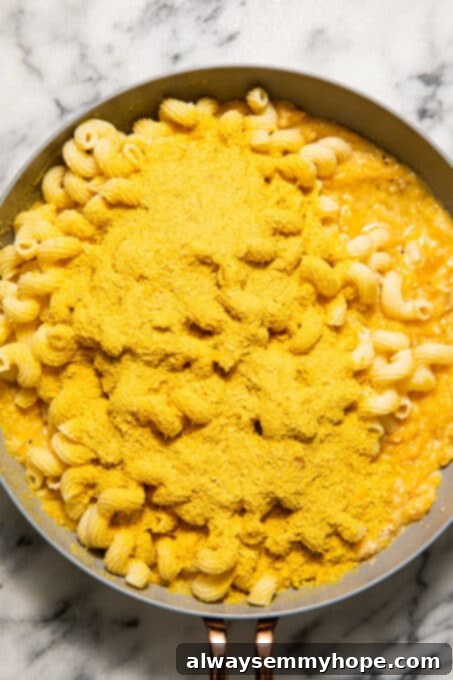 Mac and cheese mixture with nutritional yeast added, ready for baking.