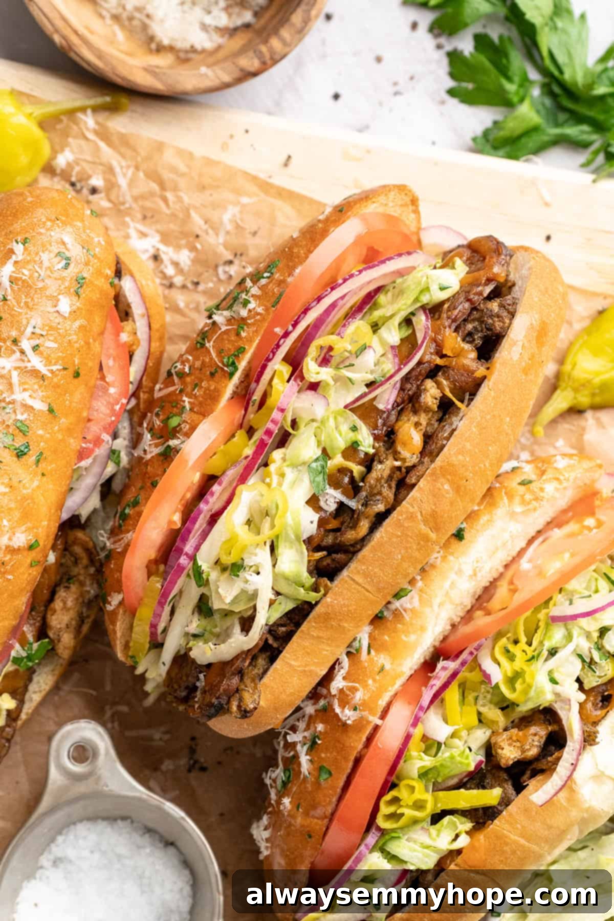 Vegan grinder sandwiches on wooden board.