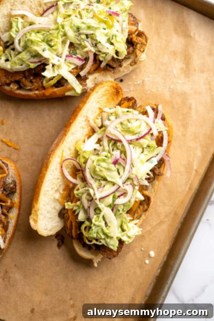 Slaw added to vegan grinder sandwich.