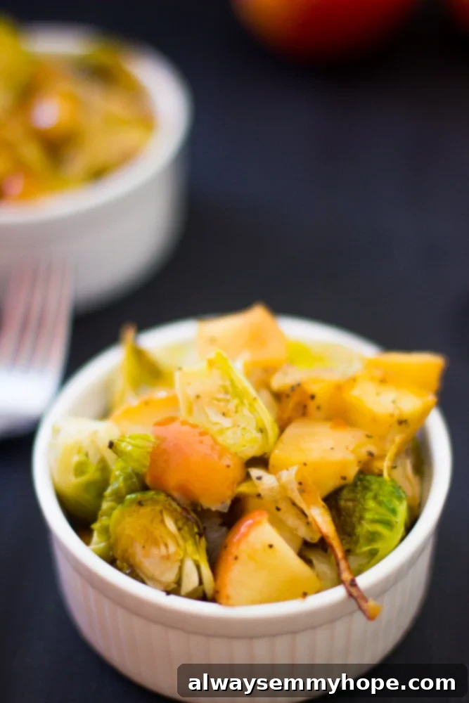 Roasted brussels sprouts in a white ramekin with a fork, ready to be enjoyed.