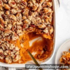 Maple Pecan Crunch Vegan Sweet Potato Bake 11 spoon in sweet potato casserole with a scoop taken out in a plate in the corner