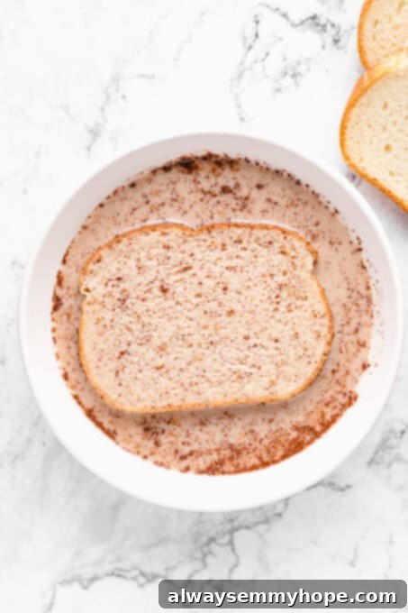 Piece of bread soaking in the milk mixture.
