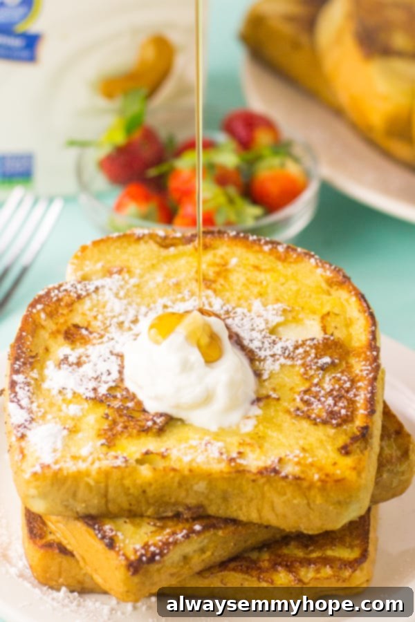 Eggnog French Toast 5 Syrup pouring on french toast.