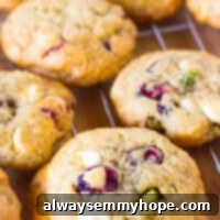 White Chocolate Cranberry Pistachio Gluten Free Cookies 6 Top down shot of freshly baked white chocolate cranberry pistachio cookies on a wire rack.