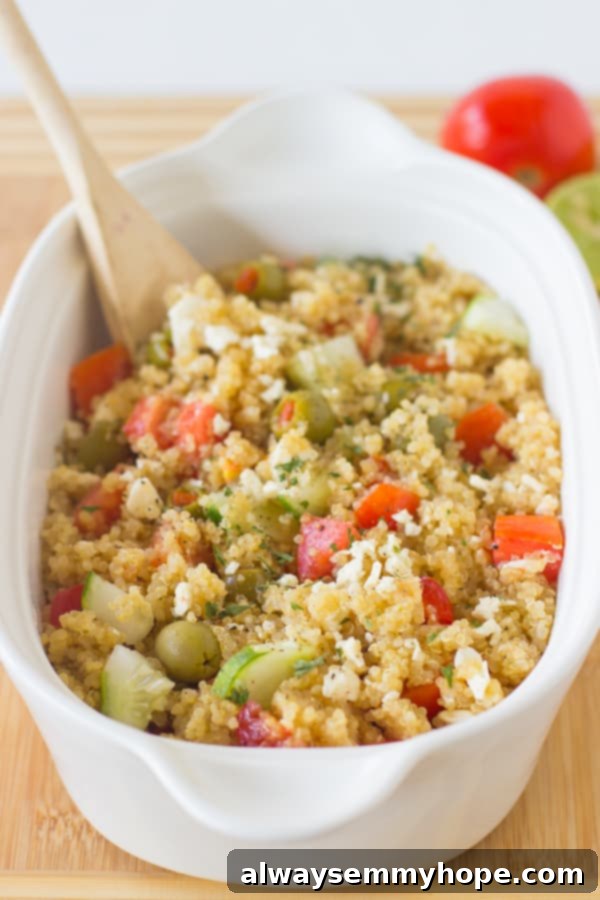 Freshly made Mediterranean Quinoa Salad bowl with cucumbers, olives, feta, and tomatoes