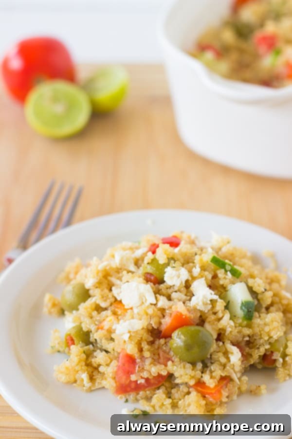 Close-up of Mediterranean Quinoa Salad with a fork, showing the texture and fresh ingredients