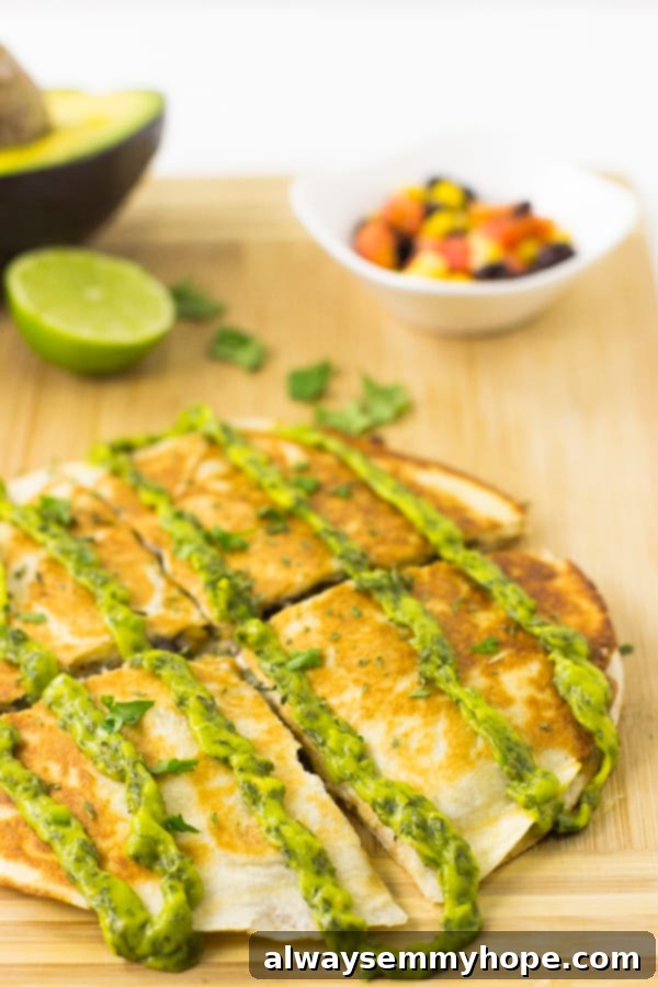 Sliced vegan black bean quesadillas arranged beautifully on a wooden board, showcasing the golden-brown tortillas and flavorful filling.