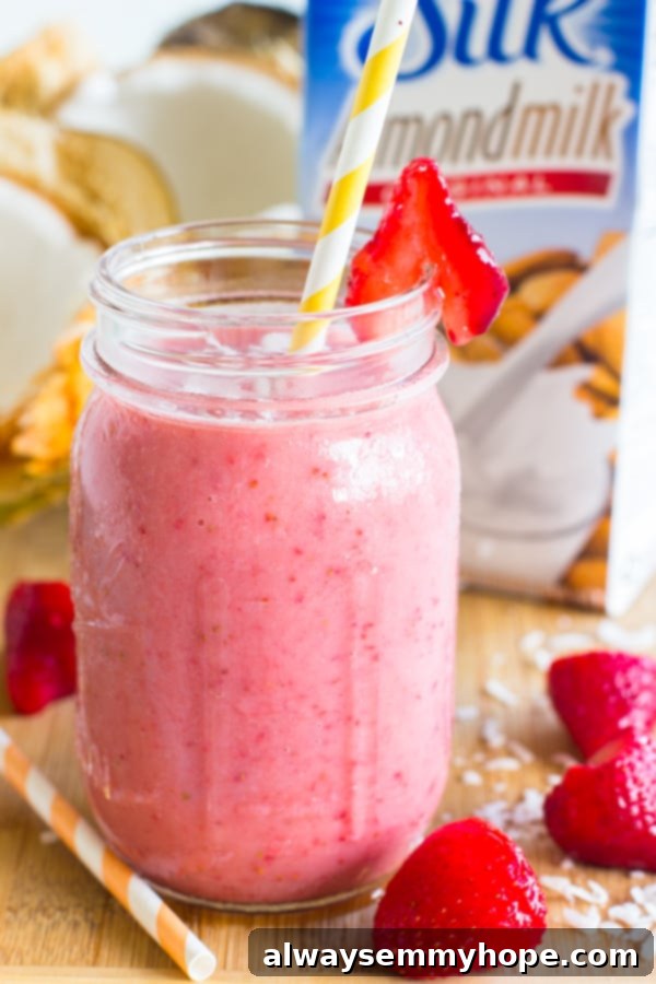 Side shot of strawberry coconut smoothie in a mason jar.