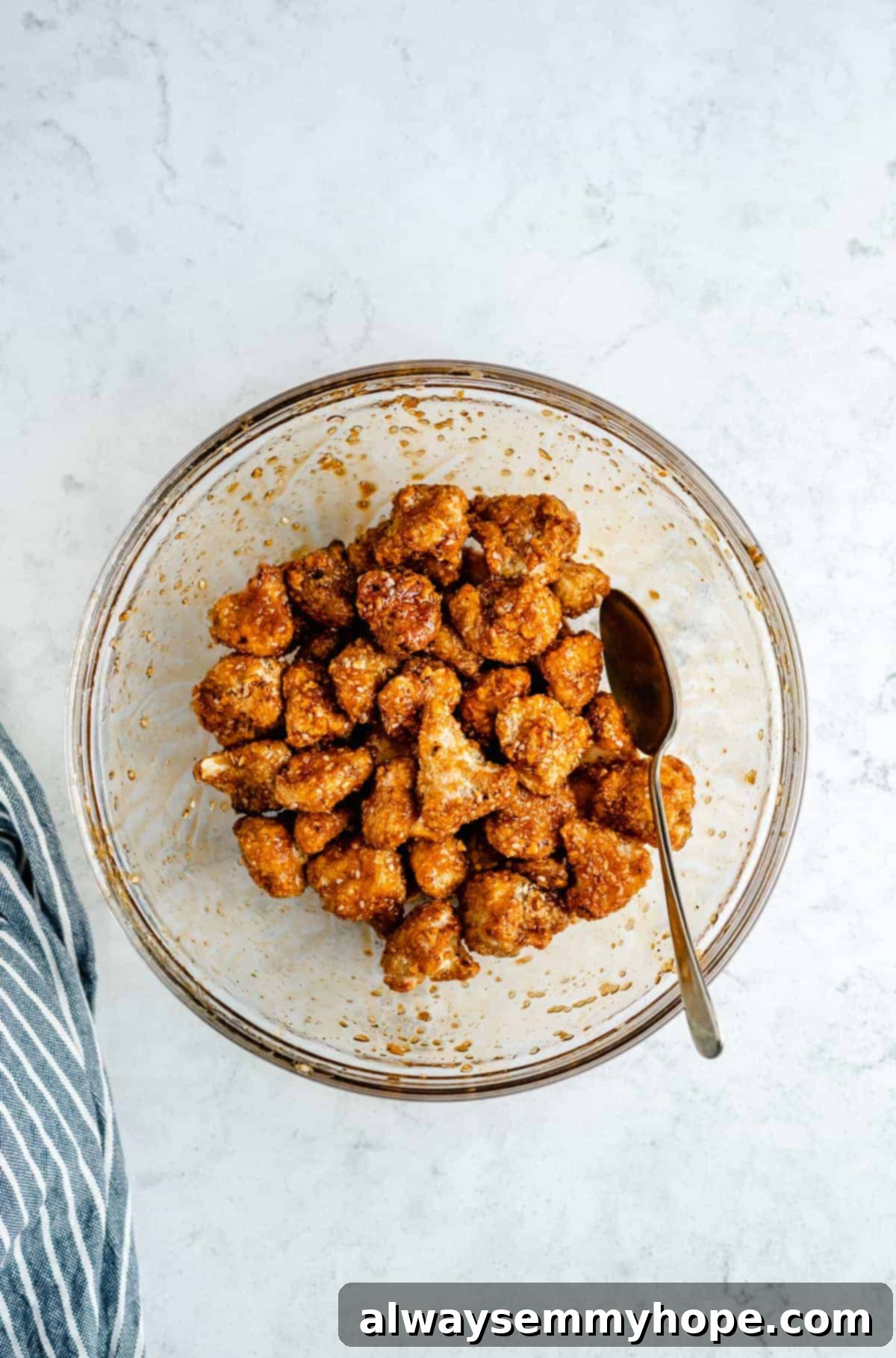 mixing of the cauliflower into the sauce before baking again