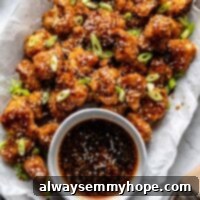 plate of cauliflower wings in a tray with sauce in a small bowl beside it