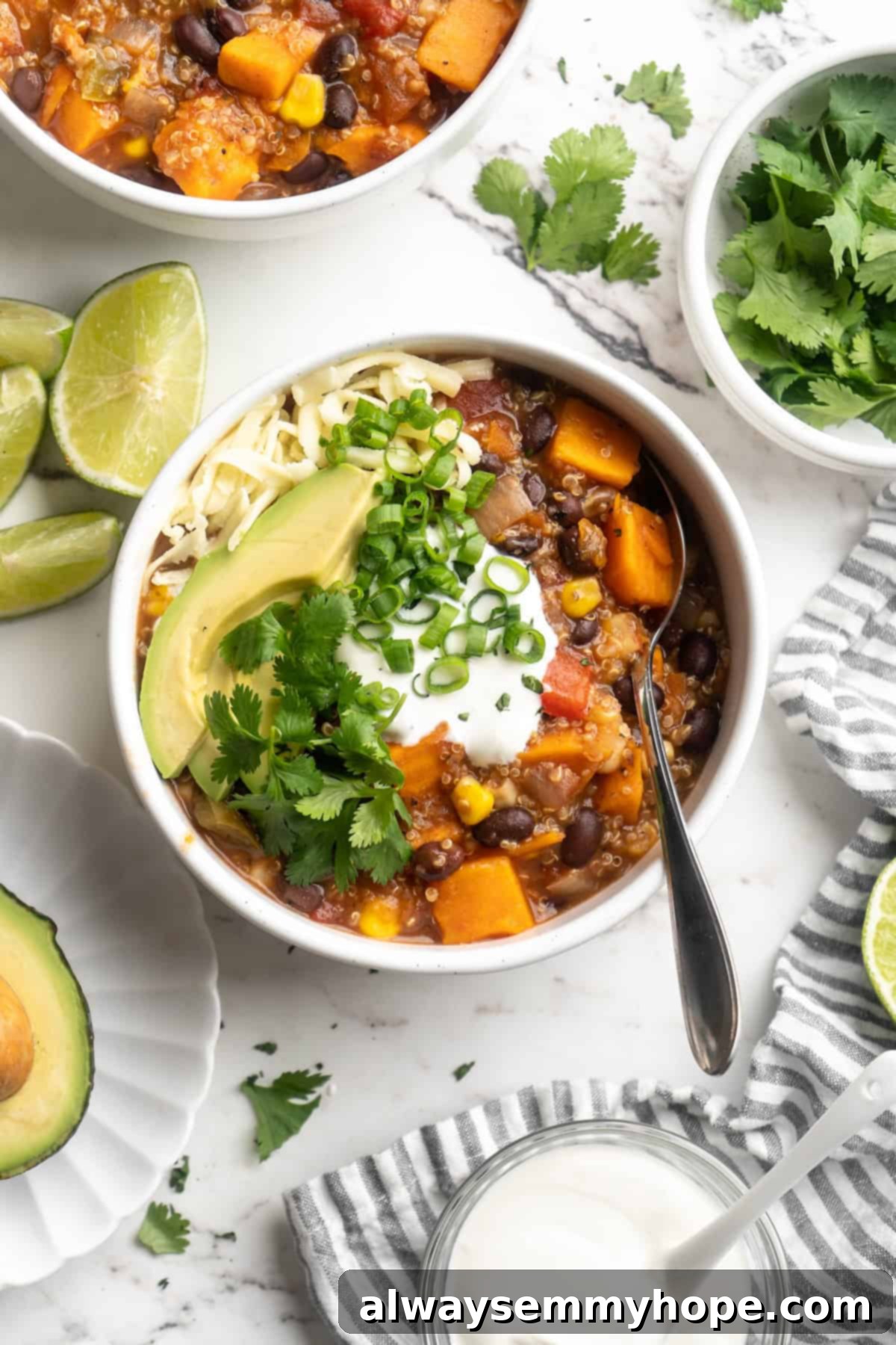 Overhead view of vegan sweet potato and black bean chili in bowl with spoon