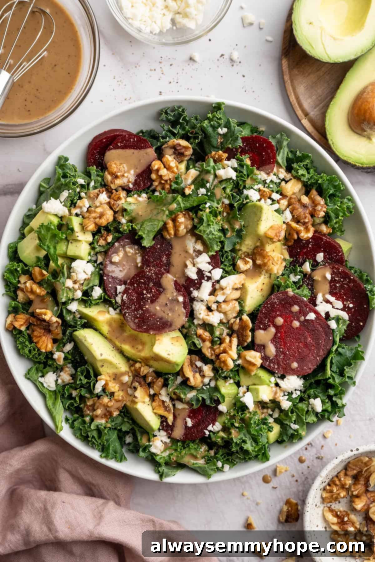 This beet feta salad pairs tender roasted beets and tangy vegan feta, along with a zippy maple mustard vinaigrette. Delicious and easy! Overhead view of vegan beet feta salad in bowl