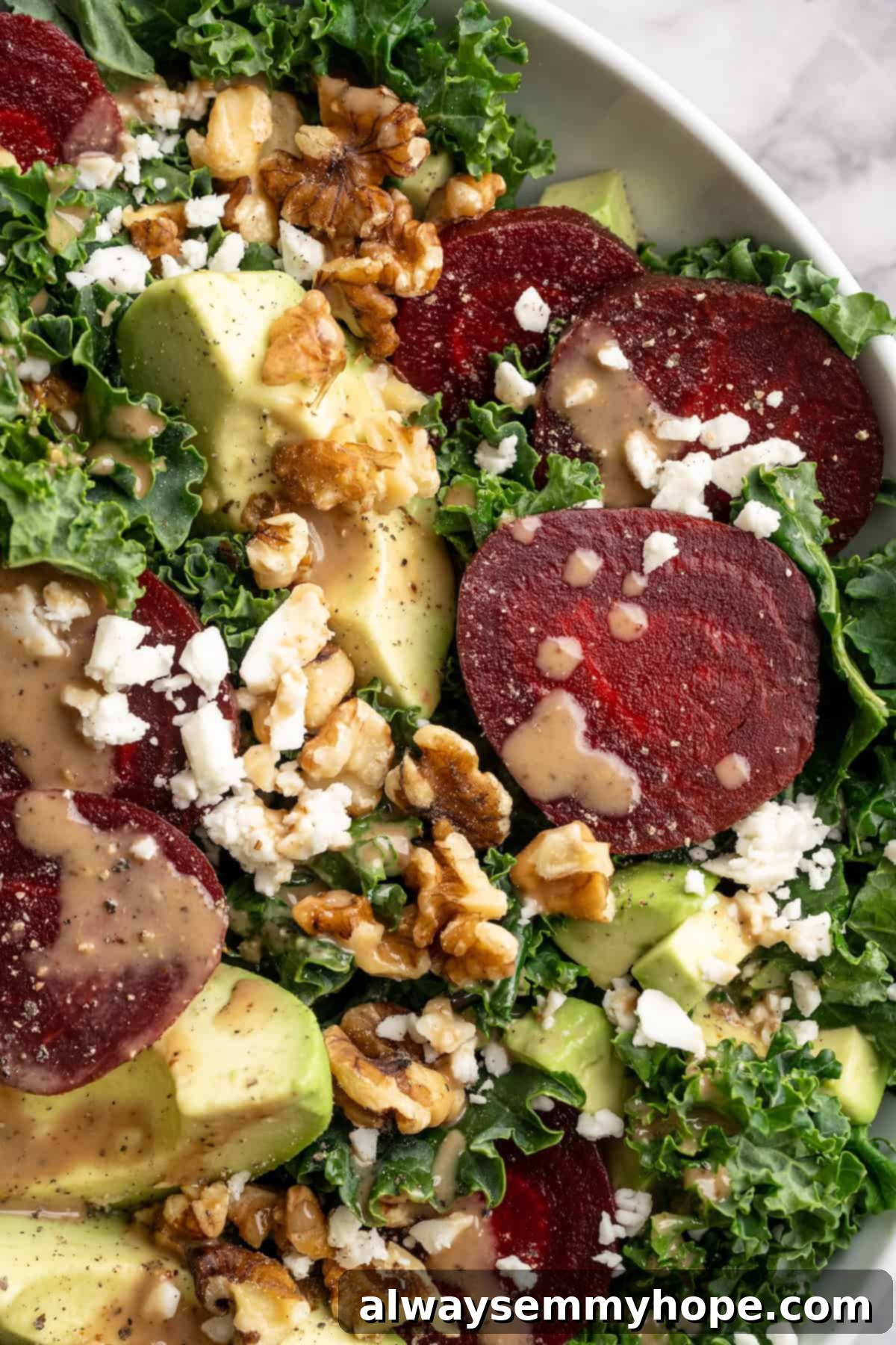 This beet feta salad pairs tender roasted beets and tangy vegan feta, along with a zippy maple mustard vinaigrette. Delicious and easy! Overhead view of vegan beet feta salad in bowl