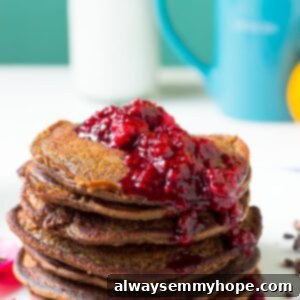 A stack of chocolate peanut butter pancakes with raspberry compote