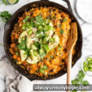 Vegan enchilada skillet with garnishes and serving spoon