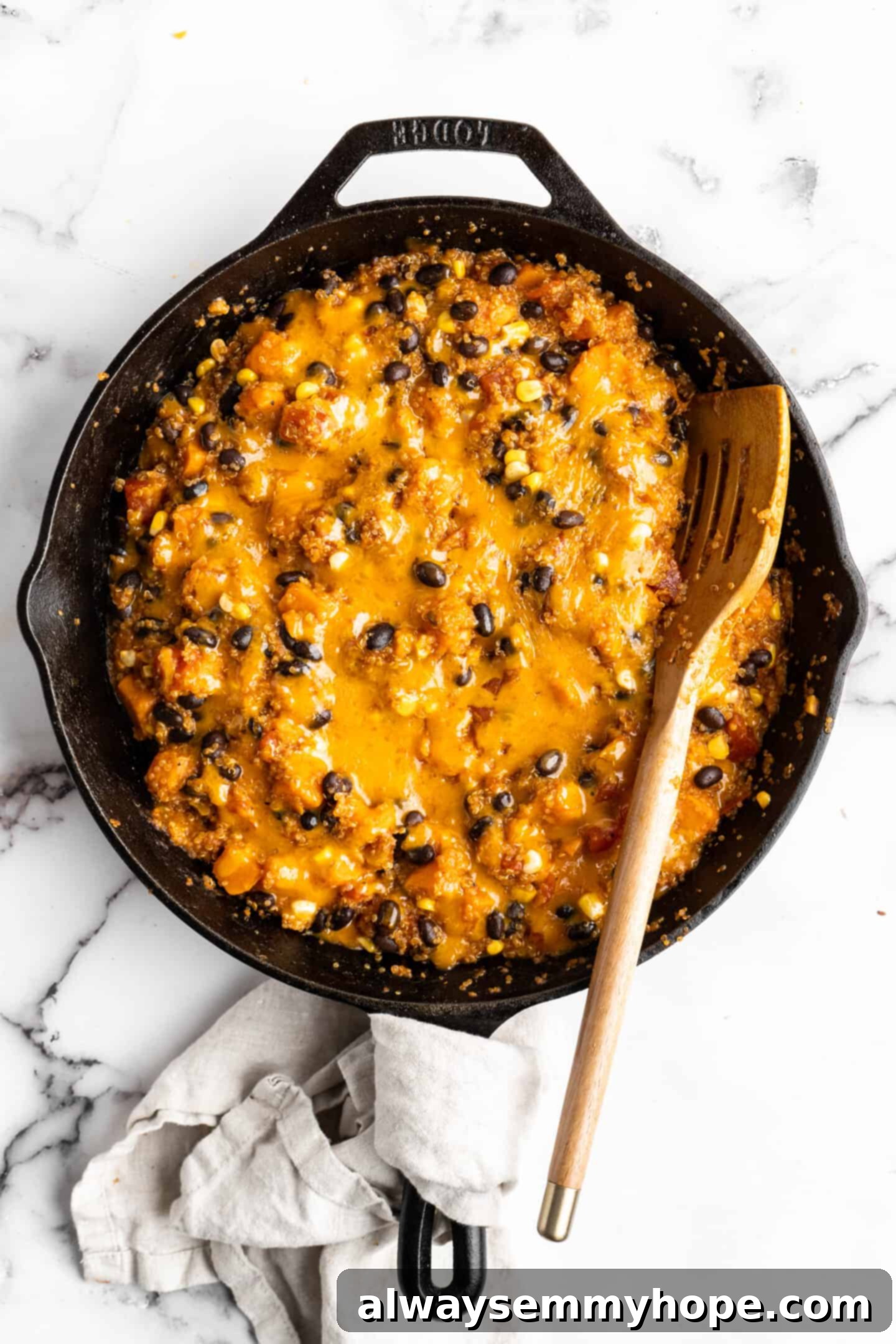 The finished cheesy vegan enchilada skillet, covered with melted vegan cheese, hot and ready to serve.