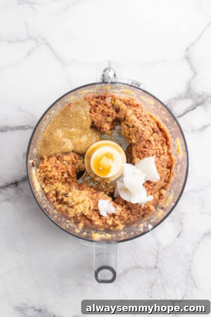 If you like your vegetarian meatballs with beans, veggies and BIG flavor, these chickpea and beet meatballs are for you. Great for meal prep! Ingredients for chickpea and beet vegetarian meatballs including spices, liquids, and flax egg added to the food processor.