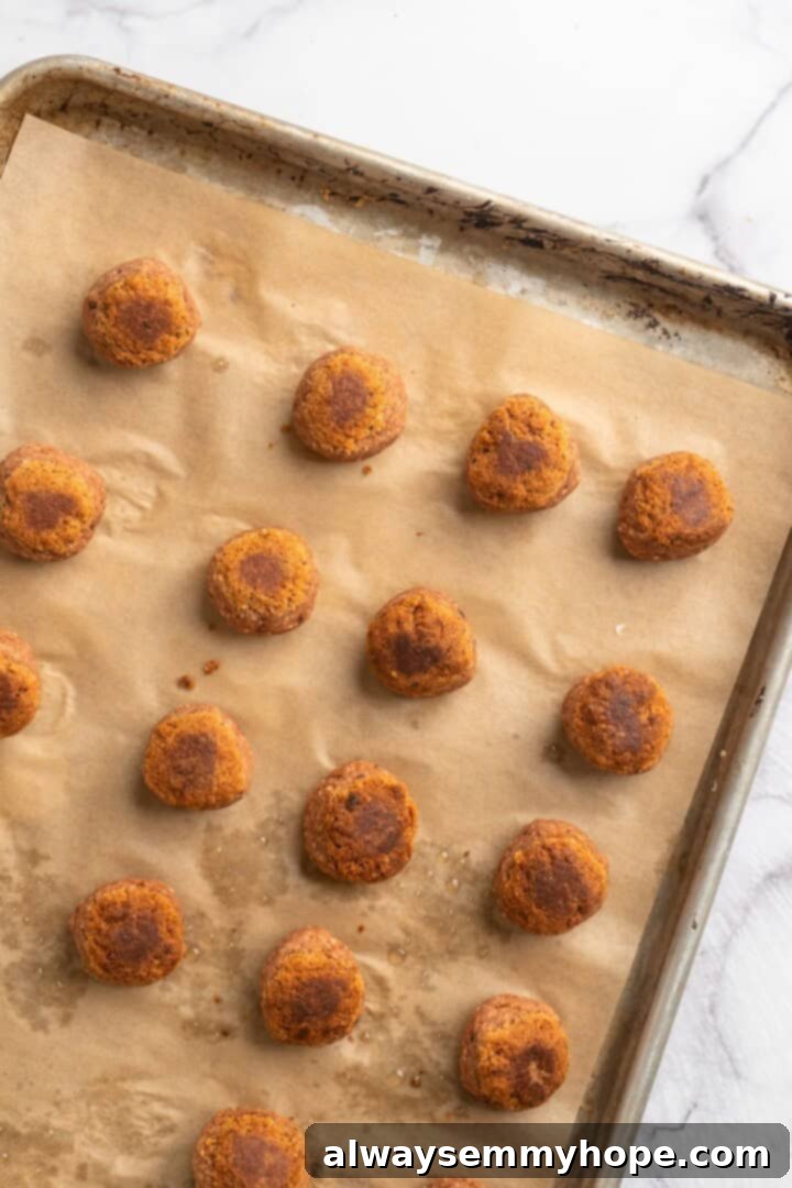 If you like your vegetarian meatballs with beans, veggies and BIG flavor, these chickpea and beet meatballs are for you. Great for meal prep! Overhead view of golden-brown chickpea and beet vegetarian meatballs fresh out of the oven, still on the baking sheet.