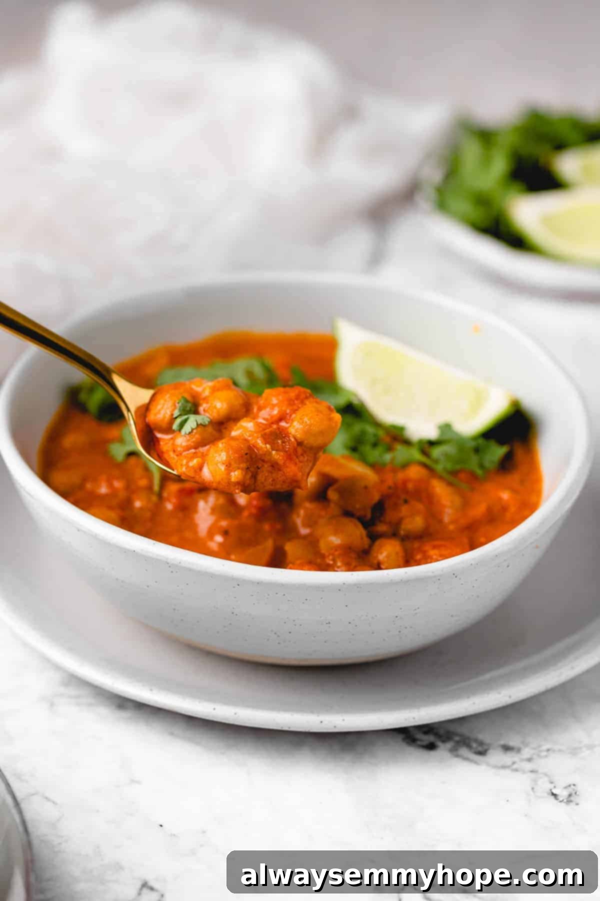 A serving of creamy vegan coconut chickpea curry, showcasing the vibrant colors and rich sauce.