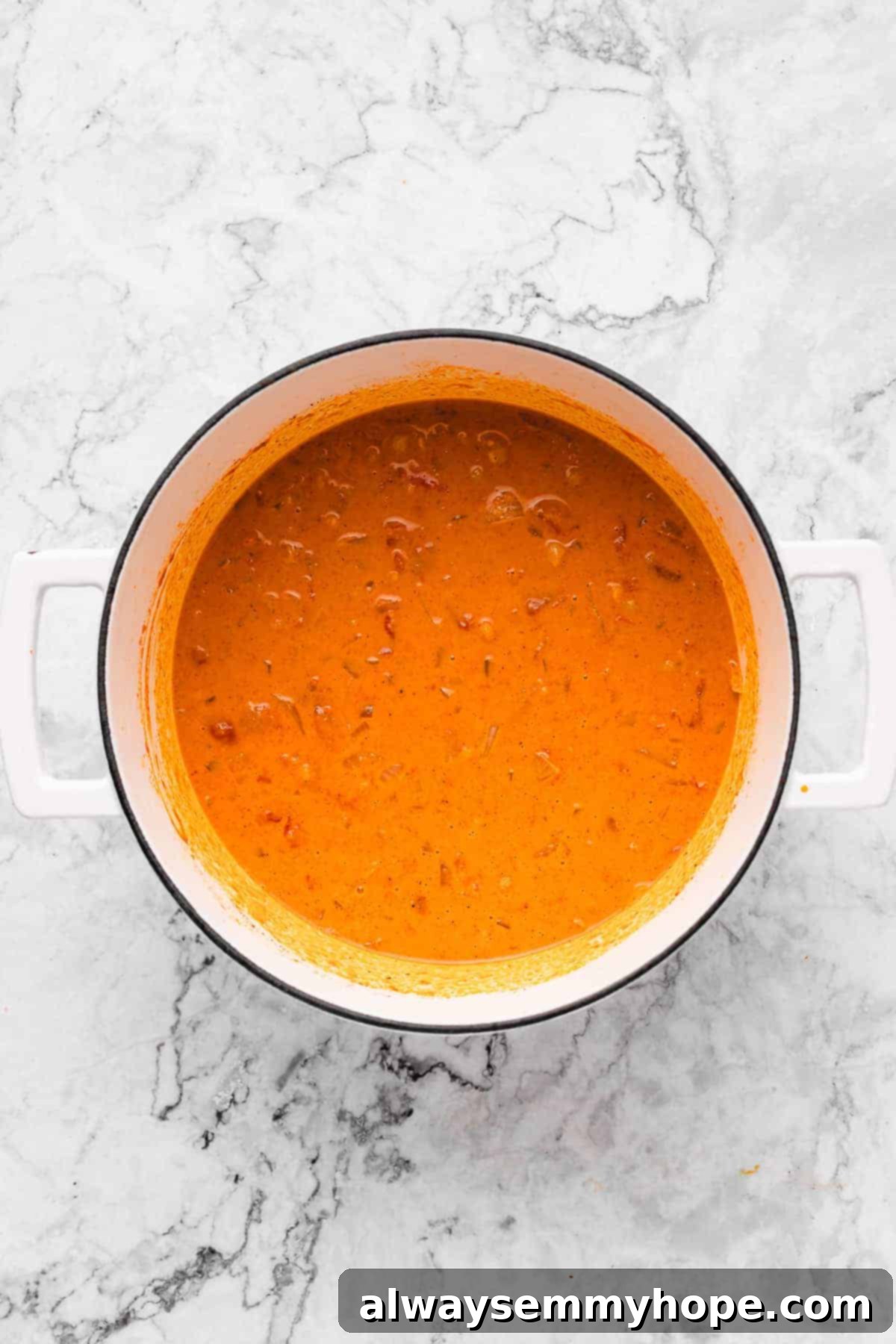 The creamy vegan coconut chickpea curry simmering gently in a deep pot.