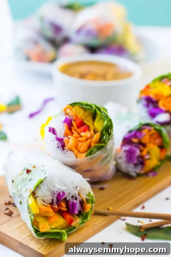 Four fresh spring rolls on a wood board. 