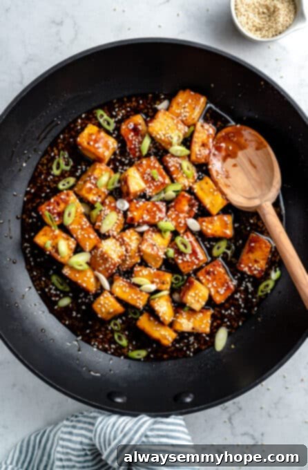 Tofu cooking with chopped scallions.