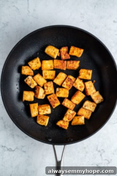 Crispy tofu in a frying pan.