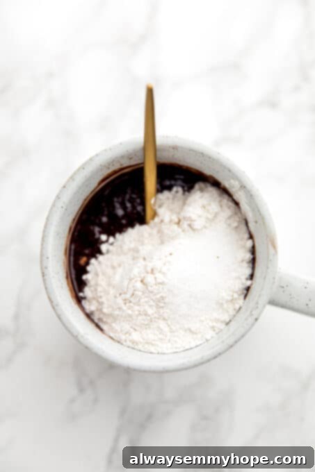 Easy Vegan Mug Brownie 9 Brownie batter, flour, and salt in a mug.