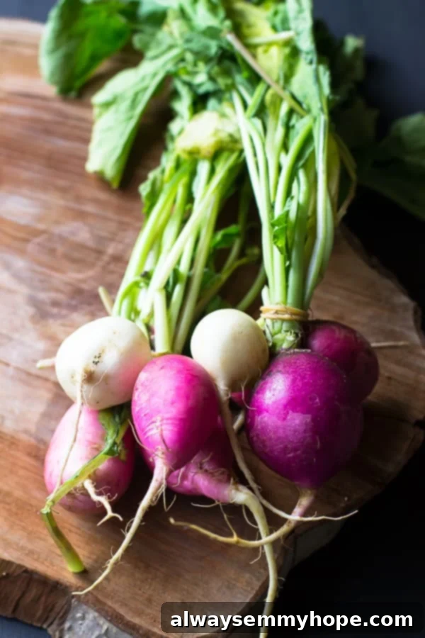April Bounty Produce Guide 4 A top-down shot of freshly harvested, vibrant Easter egg radishes, showcasing their beautiful colors on a rustic wooden board.