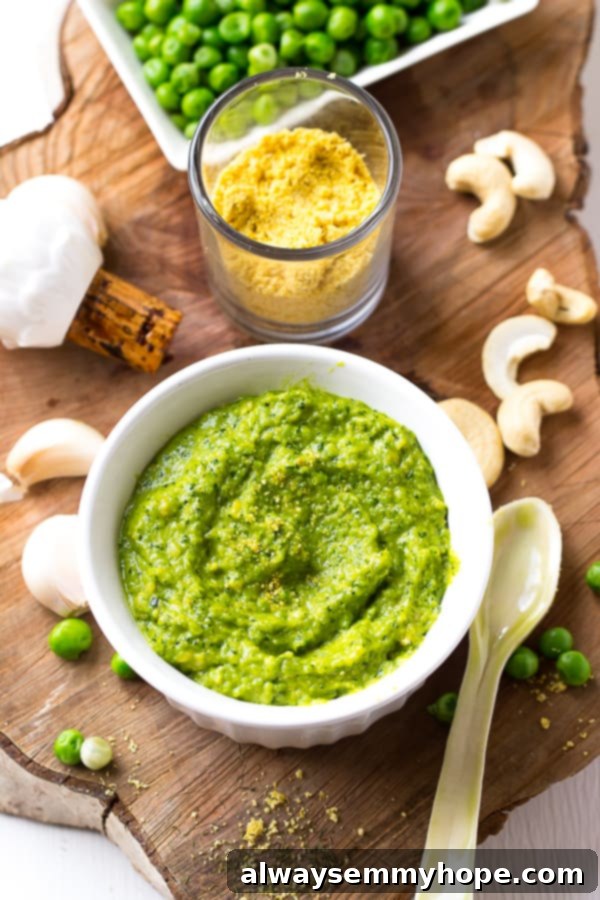 Top down shot creamy cashew pea pesto in a white bowl. 