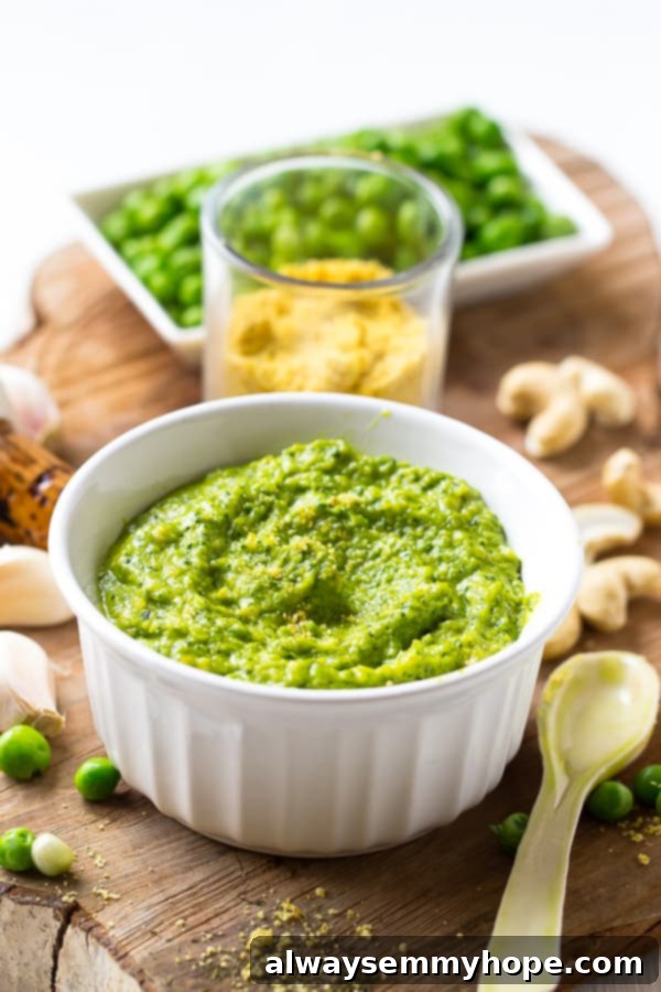  Pea Pesto in a white ramekin with a spoon on the side. 