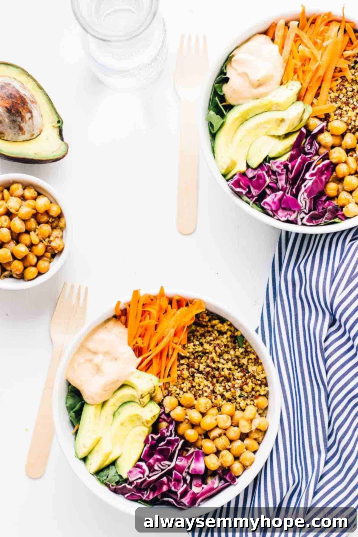 Nourishing Buddha Bowl with Harissa Tahini Dressing 3 Overhead shot of two nourish buddha bowls on a white table.